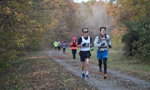 Corredores en una pista al aire libre en otoño