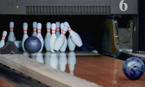 Bolas de bolos chocan contra bolos en una bolera